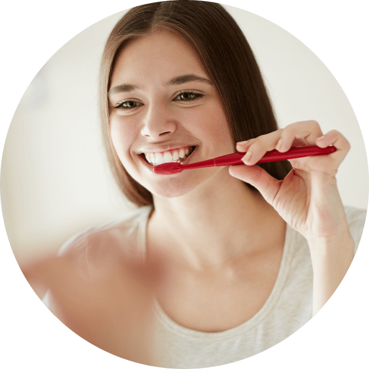 dental patient brushing her teeth