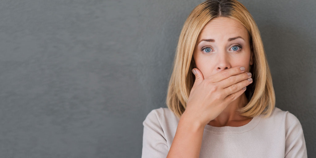 dental patient covering her mouth